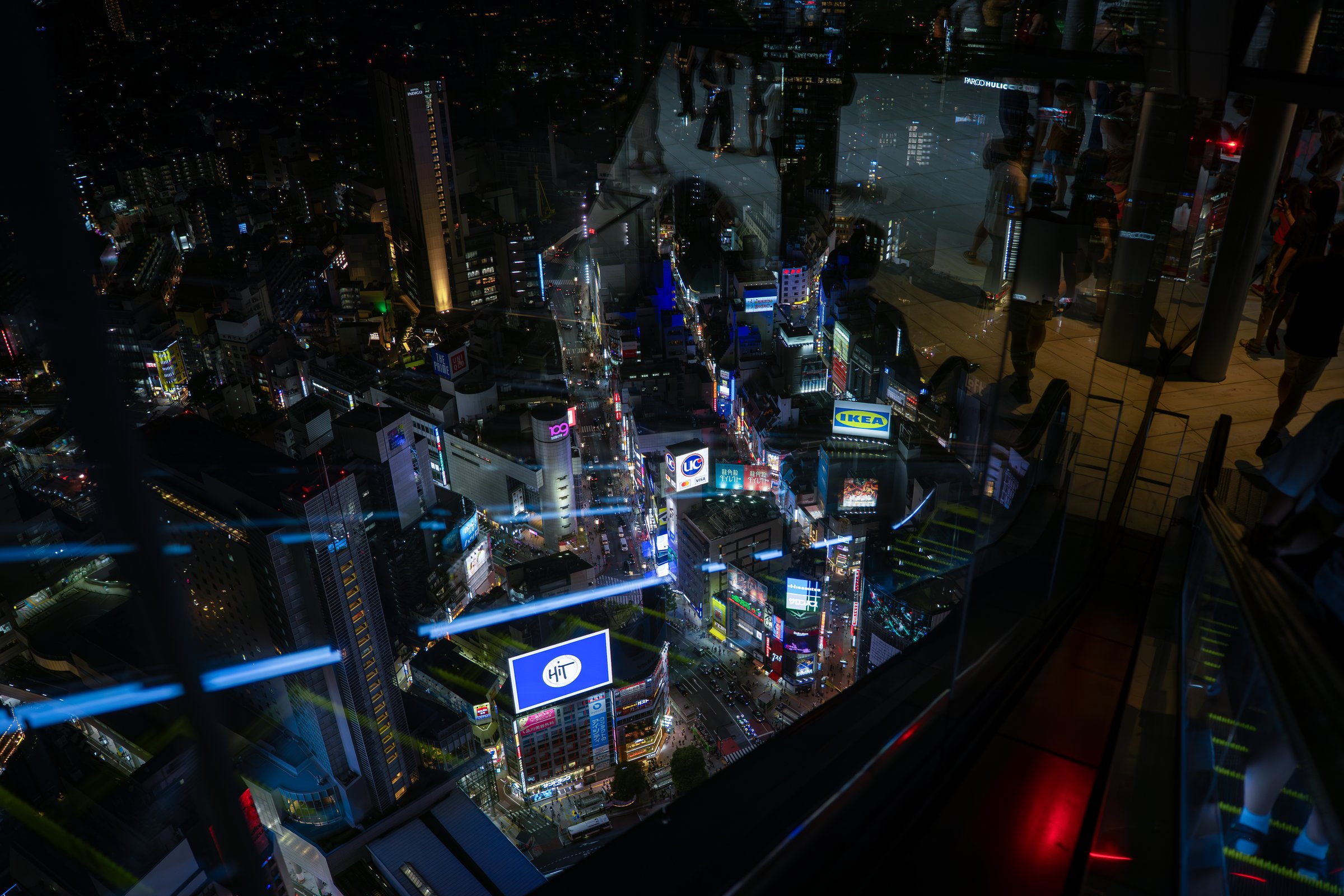 Bird's-eye view of Tokyo city block at night, neon lights